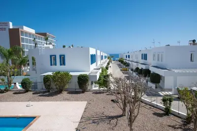 a view of a row of white buildings at The Good Times Apartment in Protaras