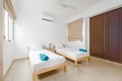 a bedroom with two beds and a window at Spacious Villa with Private Pool & Breathtaking Panoramic Ayia Napa views in Ayia Napa