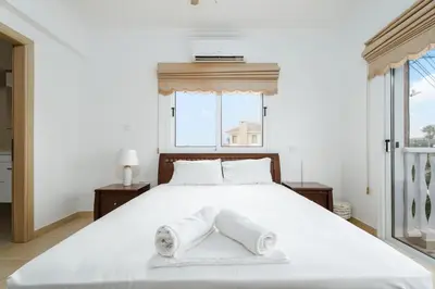 a bedroom with a large white bed with towels on it at Spacious Villa with Private Pool & Breathtaking Panoramic Ayia Napa views in Ayia Napa