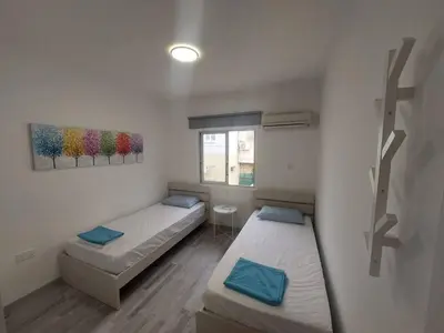 a small room with two beds and a window at AMAZING TWO BEDROOM APARTMENT in Ayia Napa