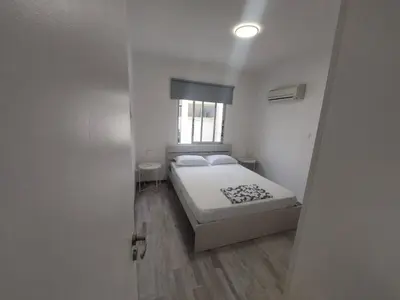 a small bedroom with a bed and a window at AMAZING TWO BEDROOM APARTMENT in Ayia Napa