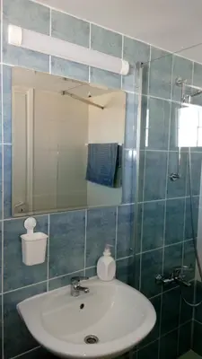 a bathroom with a sink and a mirror at GALATEX BEACH STUDIO in Limassol