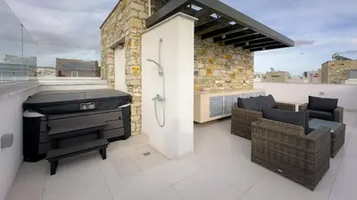 a balcony with a grill and chairs on a roof at City Napa Seaview Villas - Villa 4 in Ayia Napa