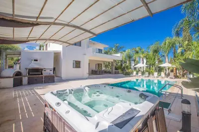 a house with a jacuzzi in the yard at Protaras Demetra Villa DE1 in Protaras