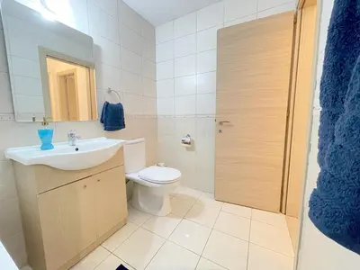 a bathroom with a toilet and a sink at Sunset Pearl Holiday Apt. - Ayia Napa in Ayia Napa