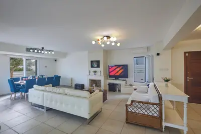 a living room with a couch and a table at Serifos Villa 7 - 100 meters from Malama Beach in Protaras
