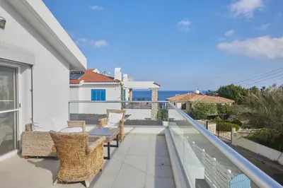 a balcony with chairs and a view of the ocean at Serifos Villa 7 - 100 meters from Malama Beach in Protaras