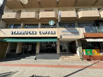 a starbucks coffee sign in front of a building at 11 Suites - Sunrise Horizon Suite in Larnaka