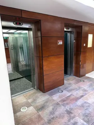 a lobby with two elevators in a building at 11 Suites - Sunrise Horizon Suite in Larnaka