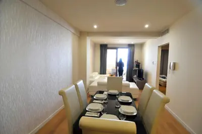 a dining room with a table and chairs and a living room at 11 Suites - Sunrise Horizon Suite in Larnaka