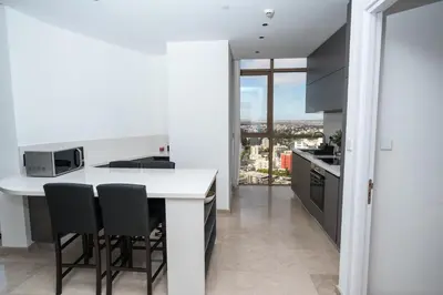 a kitchen with a white counter and black appliances at 360 Nicosia Heights, Gym & Pool in Nicosia