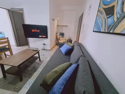 a living room with a couch and a tv at STAY Kallipoleos Apartment in Nicosia