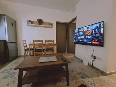 a living room with a table with a laptop on it at STAY Kallipoleos Apartment in Nicosia