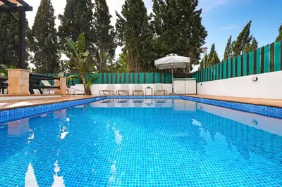 a large swimming pool with blue water at Villa Anthia - 2bed with Large Pool in Ayia Napa