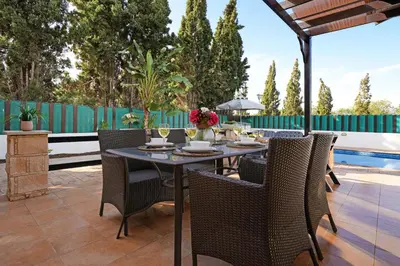 a patio with a table and chairs on a patio at Villa Anthia - 2bed with Large Pool in Ayia Napa