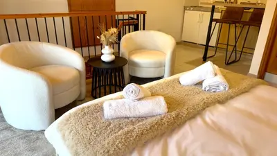 a room with two towels on a bed with two chairs at Maison Damianou Elegant Loft in Omodos