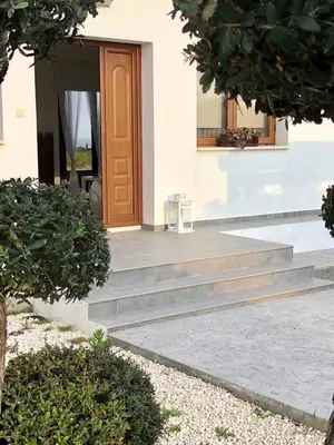 a house with stairs leading to a door at Villa Olivo Maroni in Maroni