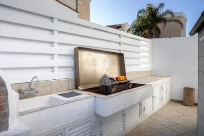 a kitchen with a sink and a counter top at Faros Seaside Villa Larnaca in Pervolia