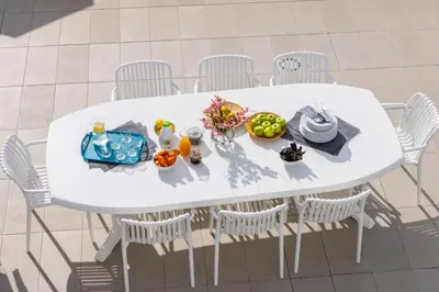 a white table with white chairs and food on it at Faros Seaside Villa Larnaca in Pervolia