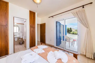 a bedroom with a bed with a view of a balcony at Villa Malamar in Protaras
