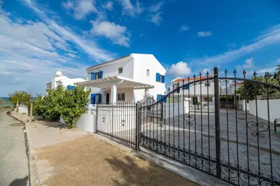 a white house with a black fence at Villa Malamar in Protaras