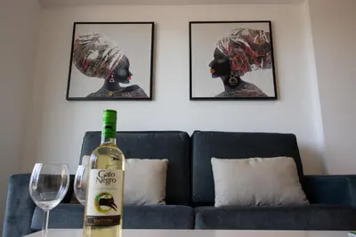 a bottle of wine sitting on a table next to a couch at Flat in Nicosia's centre in Nicosia