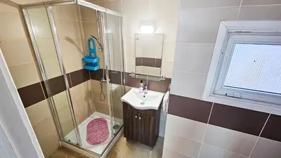a bathroom with a shower and a sink at Duplex Apartment in Larnaka