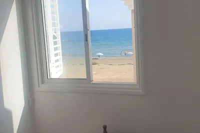 an open window with a view of the beach at Sea Heart Villa Beachfront in Pyla