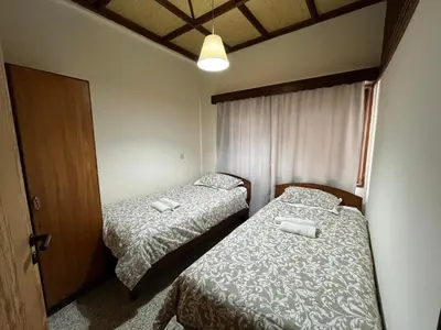 a bedroom with two beds and a door with two towels at Galata's Bridge Hotel in Galata