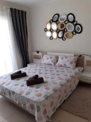 a bedroom with a bed with towels on it at Luxury Cozy Apartment near NISSI BEACH in Ayia Napa