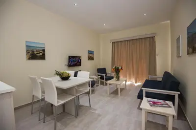 a living room with a white table and chairs at Eligonia Hotel Apartments in Ayia Napa