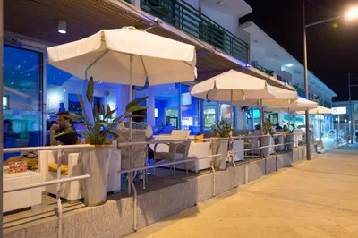 a row of tables and umbrellas at a restaurant at Eligonia Hotel Apartments in Ayia Napa