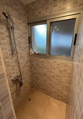 a bathroom with a shower and a window at Beautiful maisonette in Protaras in Protaras