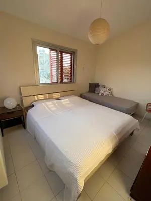 a bedroom with a large white bed and a window at Beautiful maisonette in Protaras in Protaras