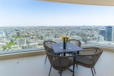 a table and chairs in a room with a large window at SkyHigh Central 360 Gym & Pool in Nicosia