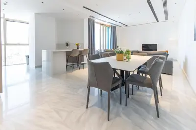 a dining room and living room with a table and chairs at SkyHigh Central 360 Gym & Pool in Nicosia