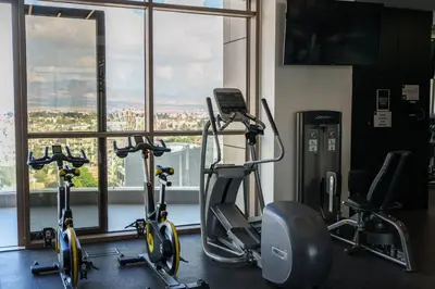 a gym with two exercise bikes in front of a window at SkyHigh Central 360 Gym & Pool in Nicosia
