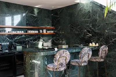 a restaurant with a black marble counter and chairs at SkyHigh Central 360 Gym & Pool in Nicosia