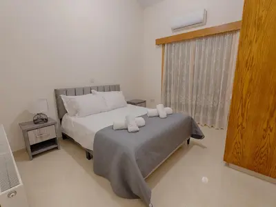 a bedroom with a bed with two towels on it at Eidyllio ''The Mansion'' in Omodos