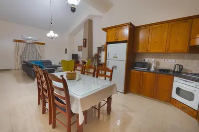 a kitchen and living room with a table and chairs at Eidyllio ''The Mansion'' in Omodos