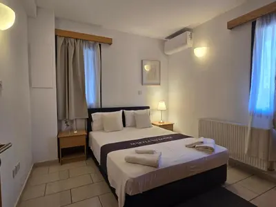 a bedroom with a bed with two towels on it at Maryland Lodge kakopetria in Kakopetria