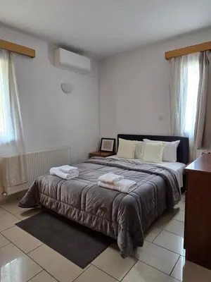 a bedroom with a large bed with towels on it at Maryland Lodge kakopetria in Kakopetria