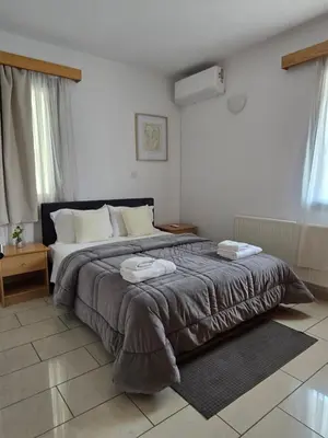 a bedroom with a large bed with two towels on it at Maryland Lodge kakopetria in Kakopetria