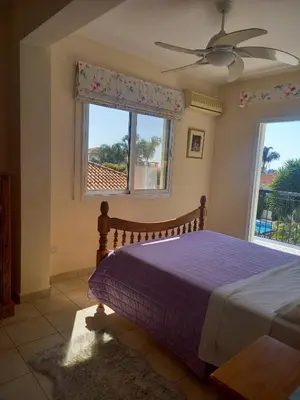 a bedroom with a bed and a window at Villa Penny in Pissouri