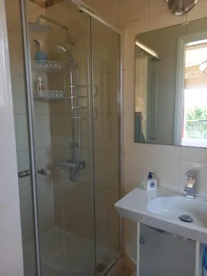 a bathroom with a shower and a sink at Villa Penny in Pissouri