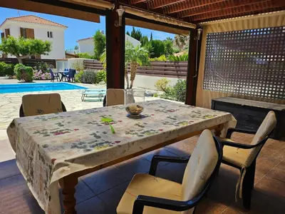 a table and chairs sitting on a patio at Villa Penny in Pissouri