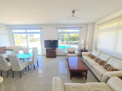 a living room with a couch and a table at Horizon Villa Protaras in Protaras