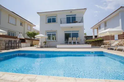 a swimming pool in front of a house at Horizon Villa Protaras in Protaras
