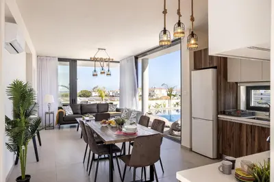 a kitchen and living room with a table and chairs at Protaras Hestia Seaside Villa B6 in Protaras