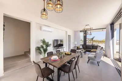 a living room with a table and chairs and a couch at Protaras Hestia Seaside Villa B6 in Protaras